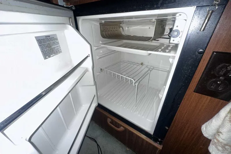 Slide: The Image of Open refrigerator inside a 1987 Sea Ray 300 Sundancer boat cabin. - 22