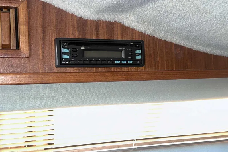 Slide: The Image of 1987 Sea Ray 300 Sundancer cabin with JVC stereo system installed in wooden panel. - 24