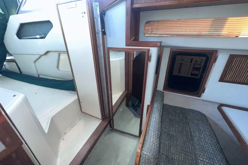 Slide: The Image of Interior of 1987 Sea Ray 300 Sundancer boat with seating and control panel. - 31