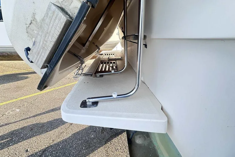 Slide: The Image of 1987 Sea Ray 300 Sundancer swim platform with ladder, viewed from the side. - 4