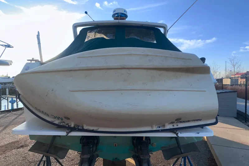 Slide: The Image of 1987 Sea Ray 300 Sundancer boat on dry dock under clear blue sky. - 7