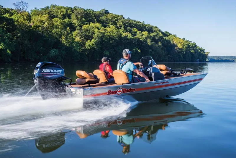 Slide: The Image of 2018 Tracker Bass Tracker 40th Anniversary Heritage Edition boat cruising on a serene lake. - 8