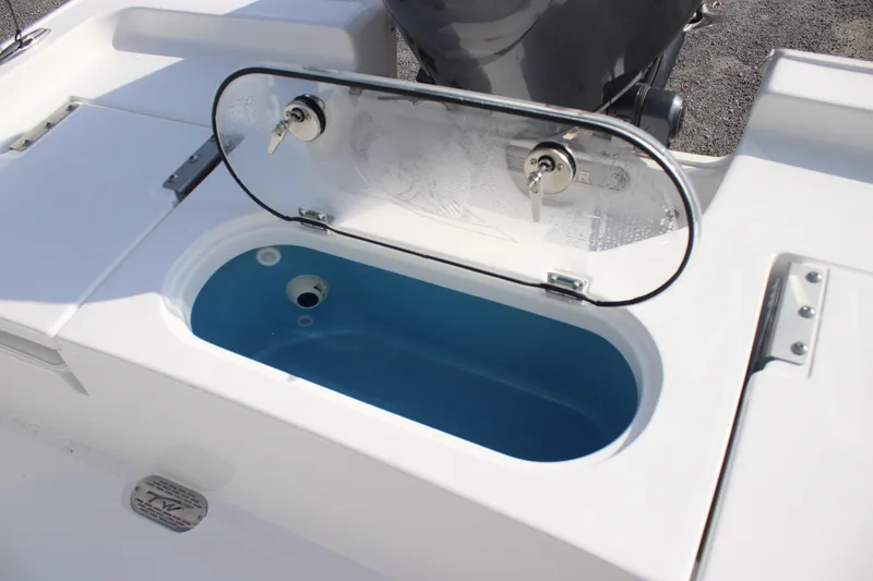 Slide: The Image of 2026 Tidewater 2110 Bay Max boat livewell with open lid, showcasing interior. - 25