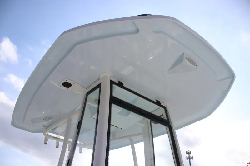 Slide: The Image of 2026 Tidewater 2110 Bay Max boat T-top against a clear sky. - 27