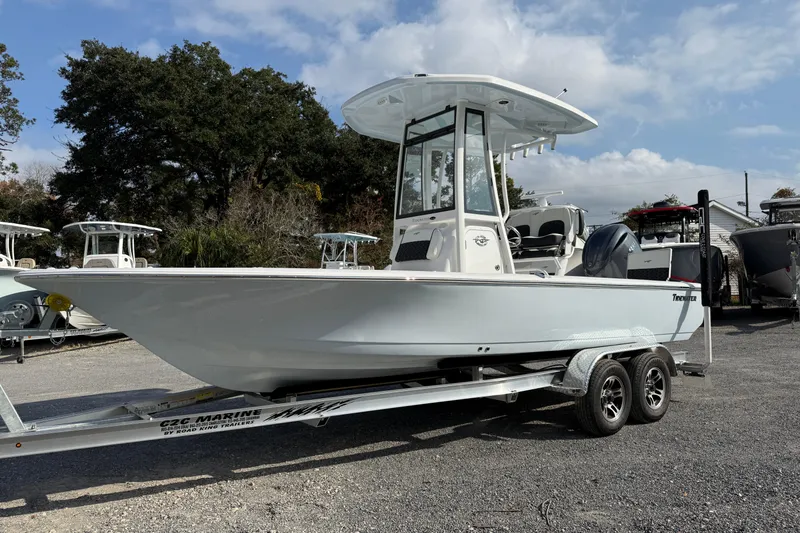 Slide: The Image of 2026 Tidewater 2110 Bay Max boat on trailer, parked outdoors under a cloudy sky. - 32