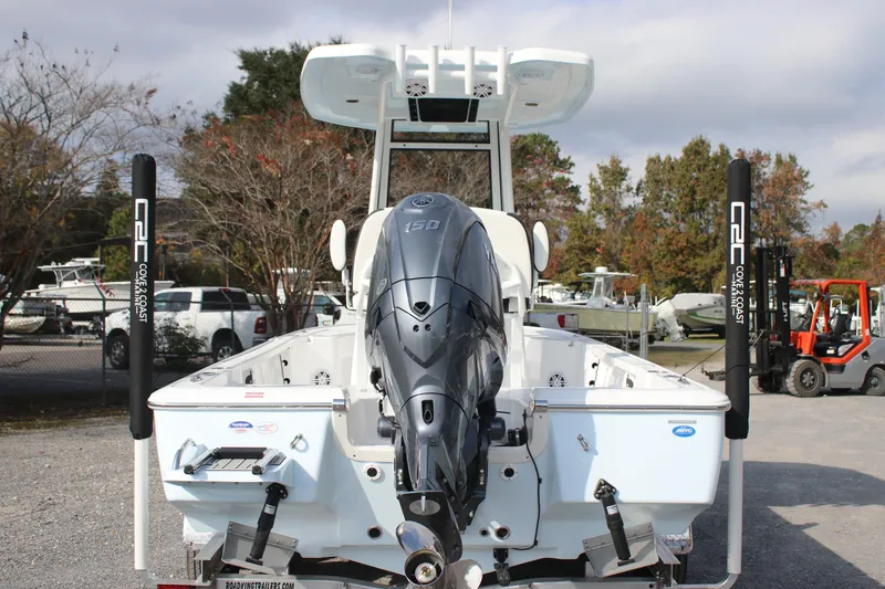 Slide: The Image of 2026 Tidewater 2110 Bay Max boat with powerful outboard motor, parked outdoors. - 5