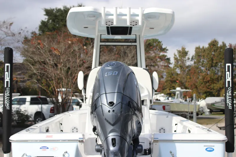 Slide: The Image of 2026 Tidewater 2110 Bay Max boat with powerful outboard motor in a marina setting. - 6