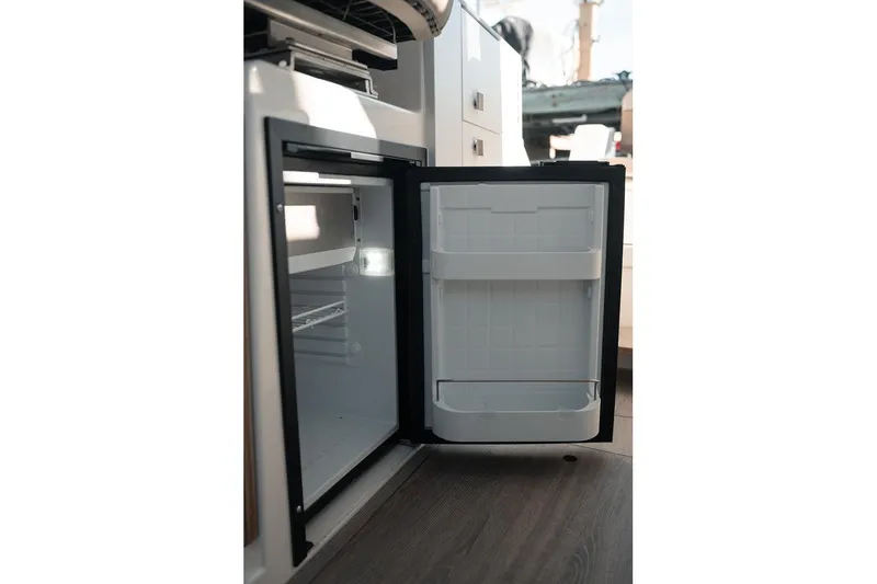 Slide: The Image of Open refrigerator inside 2026 Bayliner Trophy T23 Explorer boat cabin. - 12