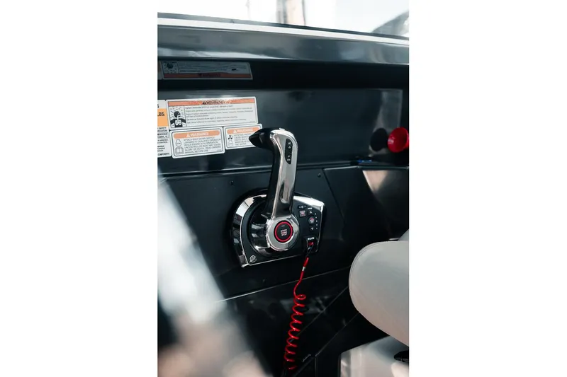 Slide: The Image of 2026 Bayliner Trophy T23 Explorer throttle control in cockpit, featuring modern design and safety warnings. - 14