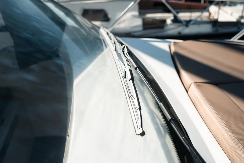 Slide: The Image of 2026 Bayliner Trophy T23 Explorer windshield and wiper detail, showcasing sleek design. - 15