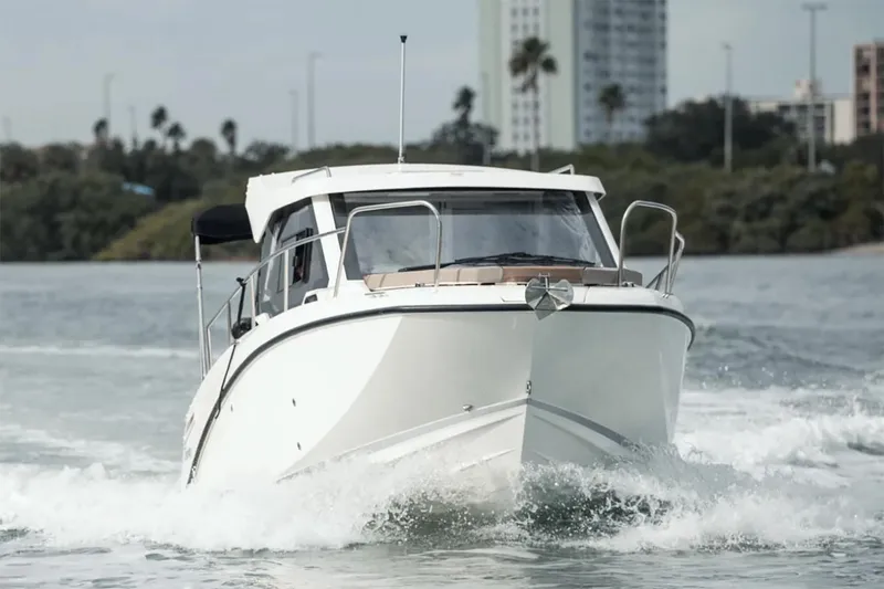 Slide: The Image of Manufacturer Provided Image: 2025 Bayliner Trophy T23 Explorer cruising on water, front view. - 2