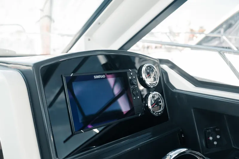 Slide: The Image of 2026 Bayliner Trophy T23 Explorer dashboard with Simrad display and gauges. - 8