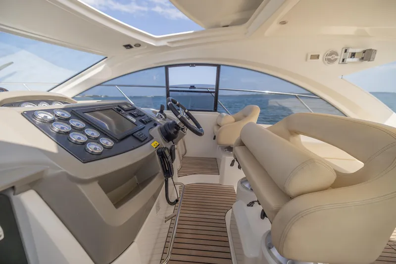 Slide: The Image of Luxurious helm of 2013 Beneteau Gran Turismo 38 yacht with modern controls and seating. - 10