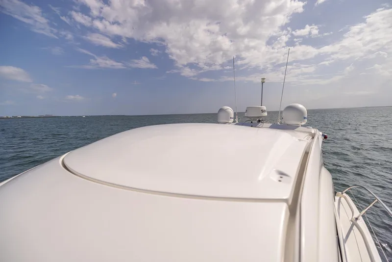 Slide: The Image of Beneteau Gran Turismo 38 yacht on open water under a partly cloudy sky. - 16
