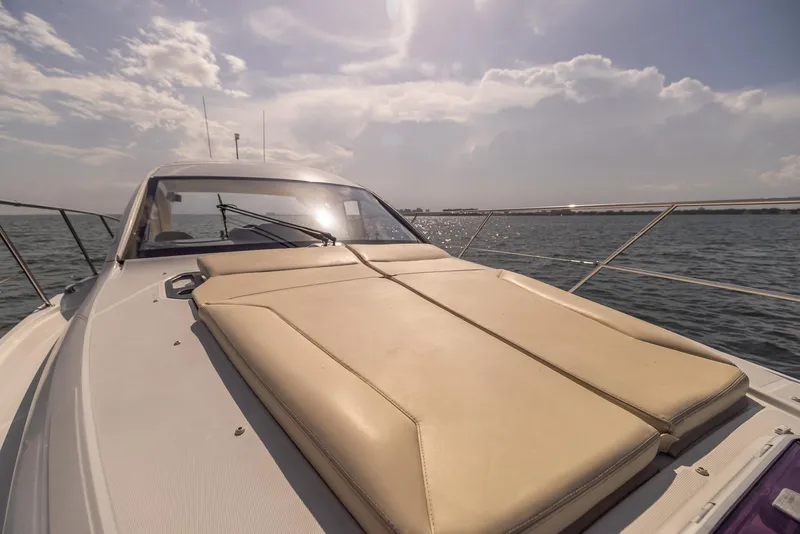 Slide: The Image of 2013 Beneteau Gran Turismo 38 yacht with sun pad, cruising on open water. - 22