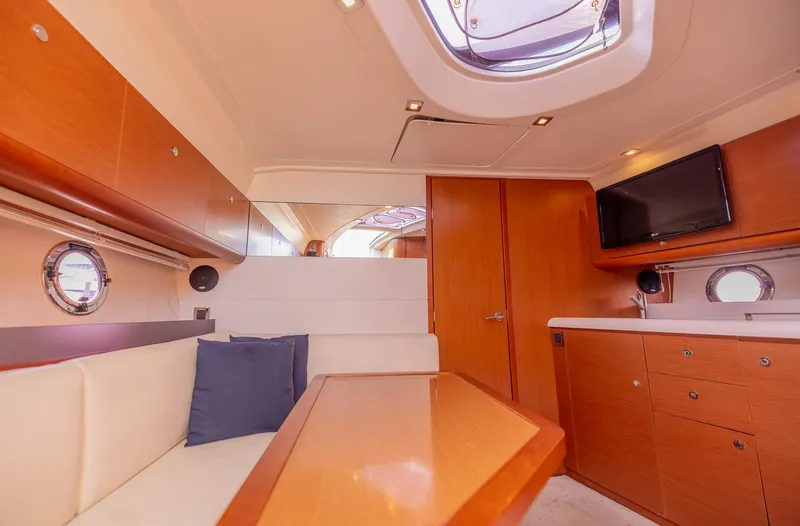 Slide: The Image of Interior of 2013 Beneteau Gran Turismo 38 yacht with modern wood finish and seating area. - 24