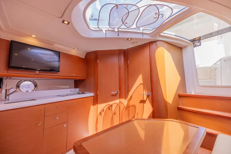 Slide: The Image of Luxurious interior of 2013 Beneteau Gran Turismo 38 yacht with modern amenities and elegant wood finish. - 27