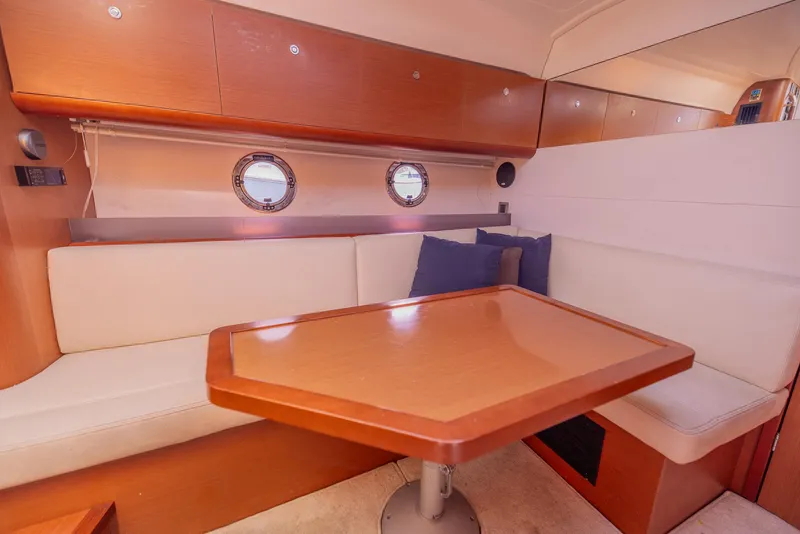 Slide: The Image of Interior of 2013 Beneteau Gran Turismo 38 yacht with cozy seating and wooden table. - 28