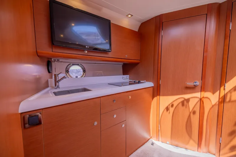 Slide: The Image of Interior of 2013 Beneteau GRAN TURISMO 38 yacht with kitchenette and TV. - 29