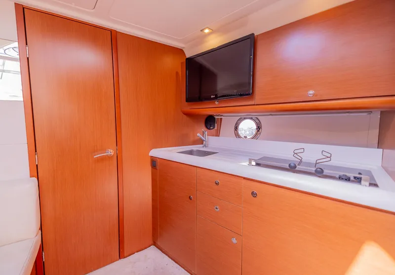 Slide: The Image of Interior of 2013 Beneteau Gran Turismo 38 yacht with kitchenette and TV. - 30