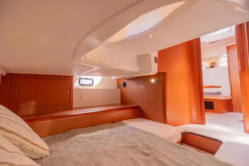 Slide: The Image of Cozy cabin interior of 2013 Beneteau Gran Turismo 38 yacht, featuring wood finishes and soft lighting. - 37