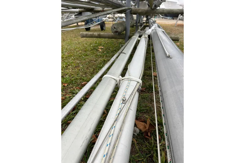 Slide: The Image of Metal poles and ropes on grass, part of a 1973 Willard 30 boat structure. - 13