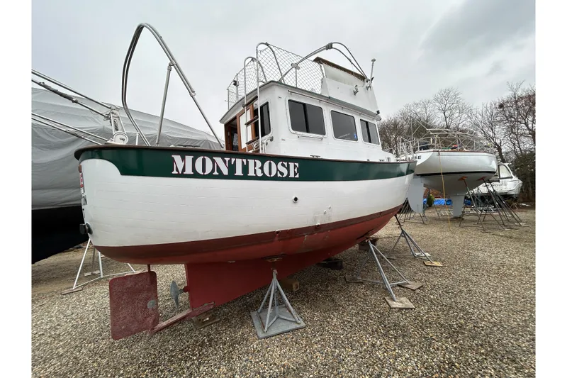 Slide: The Image of 1973 Willard 30 boat named Montrose on stands in a boatyard. - 18