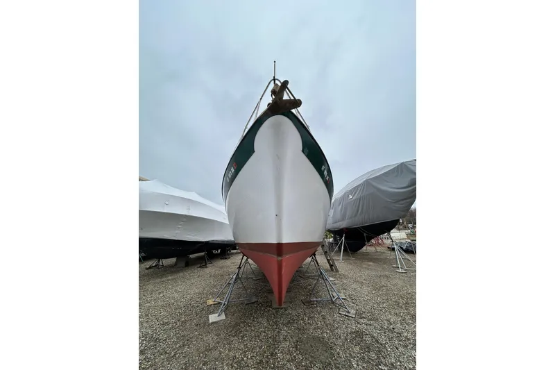 Slide: The Image of 1973 Willard 30 boat on dry dock, surrounded by covered vessels. - 19