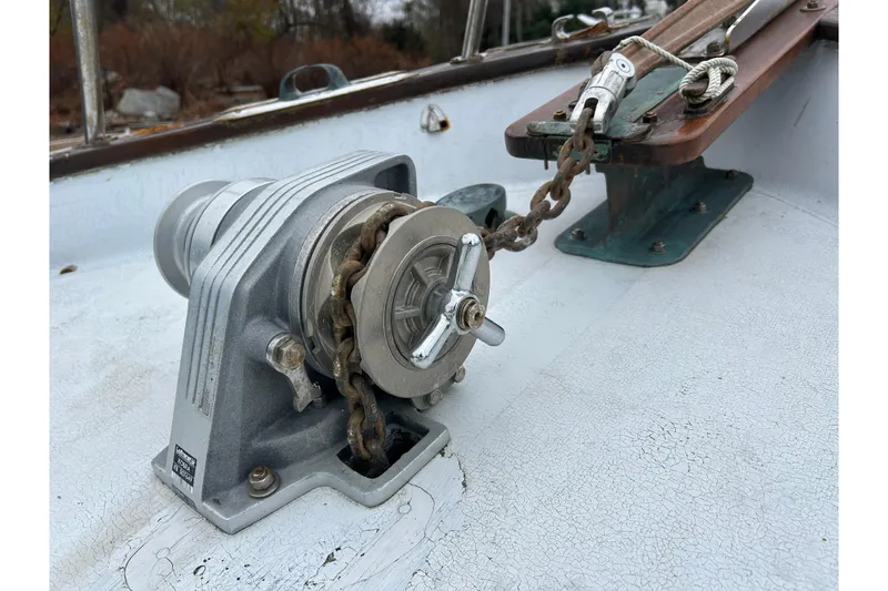 Slide: The Image of 1973 Willard 30 boat deck with anchor windlass and chain mechanism. - 30