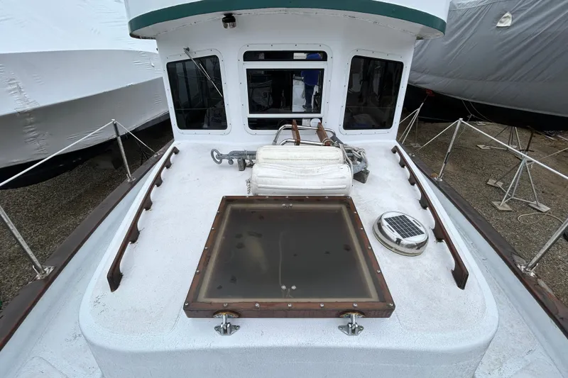 Slide: The Image of 1973 Willard 30 boat deck with windows, anchor, and equipment. - 35