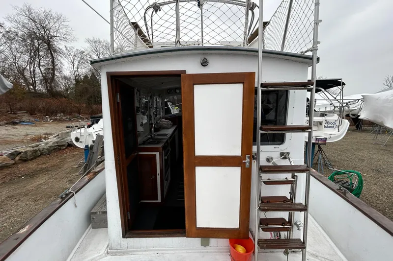 Slide: The Image of 1973 Willard 30 boat with open cabin door and exterior ladder. - 39