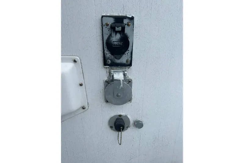 Slide: The Image of 1973 Willard 30 boat exterior with electrical and propane connections. - 43