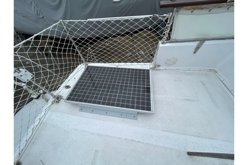 Slide: The Image of 1973 Willard 30 boat deck with solar panel and safety netting. - 48