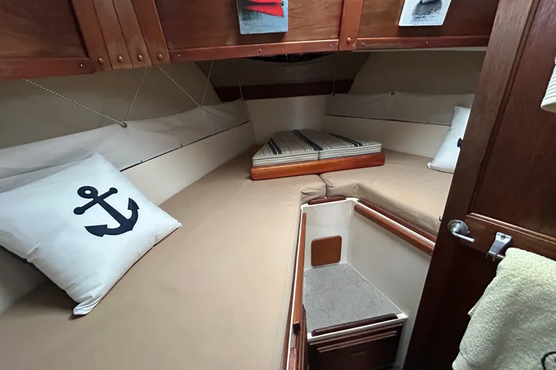 Slide: The Image of Cozy cabin interior of a 1973 Willard 30 boat with anchor-themed decor. - 5