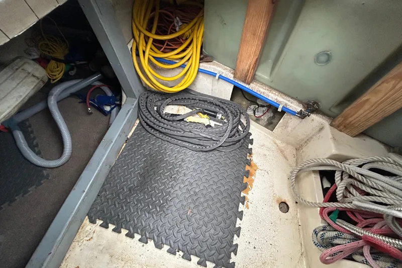 Slide: The Image of Interior of a 1973 Willard 30 boat with coiled ropes and cables. - 51