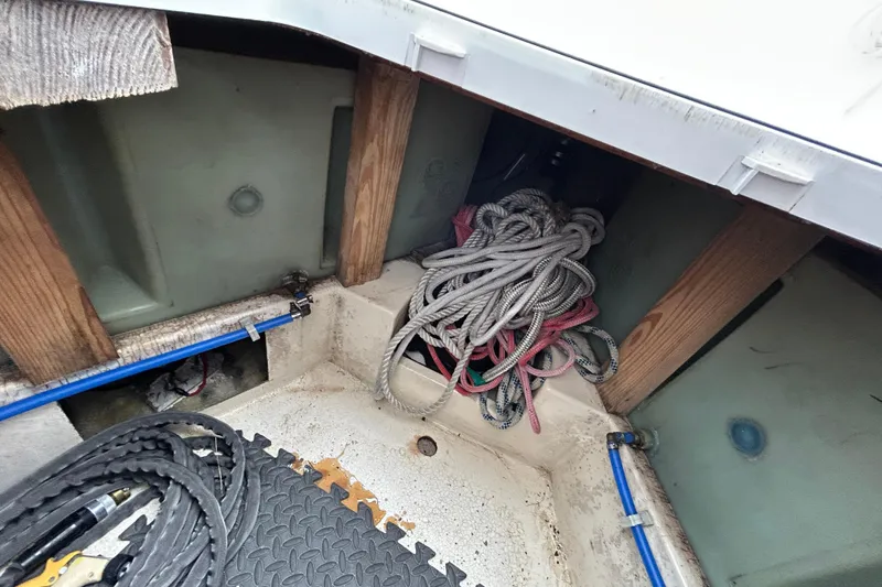 Slide: The Image of Interior of a 1973 Willard 30 boat showing ropes and wooden supports. - 52