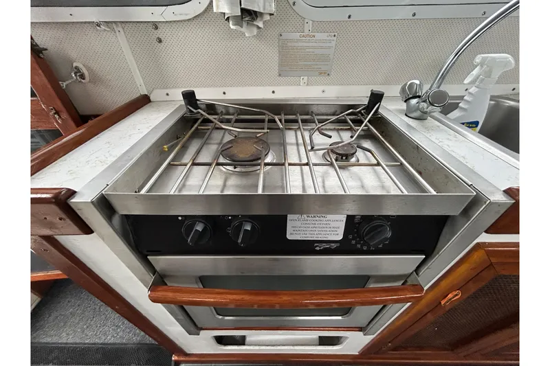 Slide: The Image of 1973 Willard 30 boat kitchen with stainless steel stove and oven. - 53