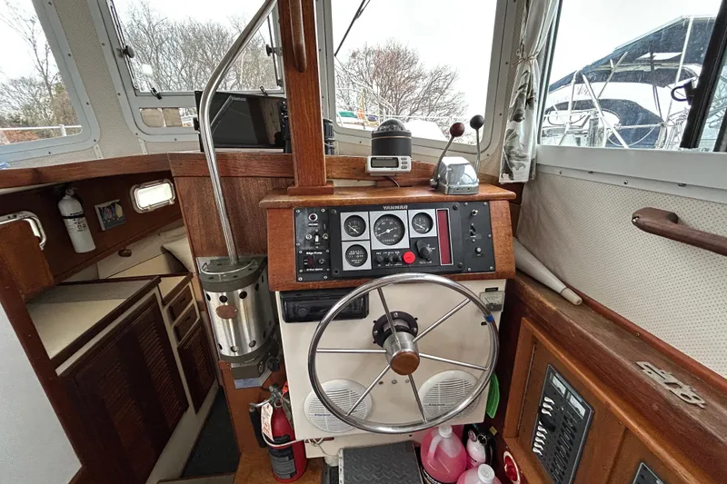 Slide: The Image of 1973 Willard 30 boat interior with steering wheel and control panel. - 55