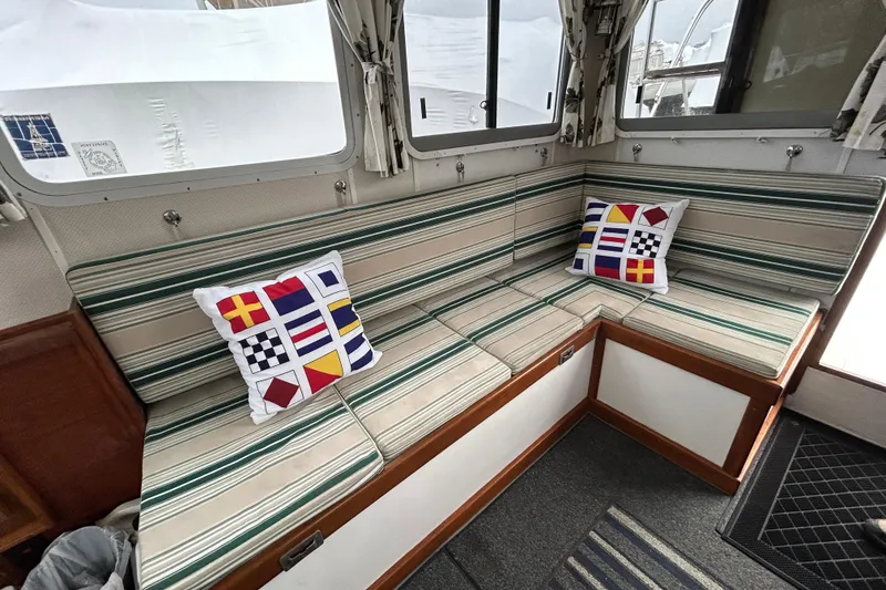 Slide: The Image of Interior of a 1973 Willard 30 boat with striped seating and nautical-themed pillows. - 59