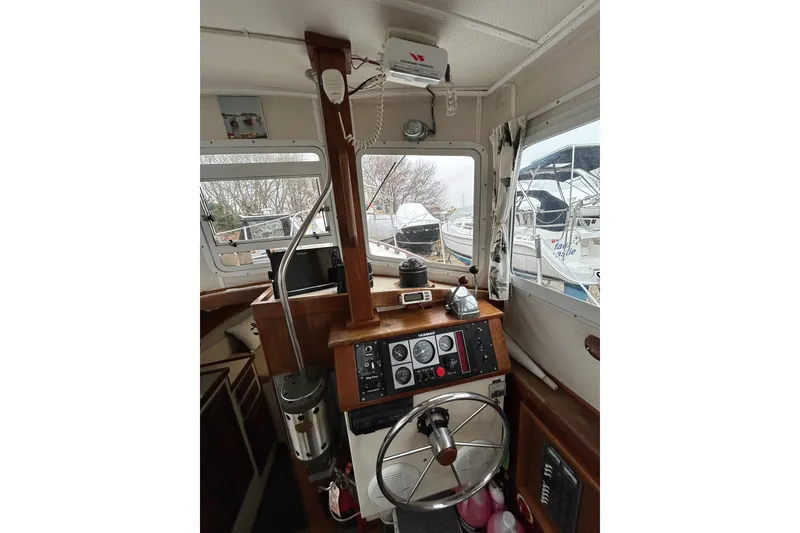 Slide: The Image of Interior of a 1973 Willard 30 boat cockpit with steering wheel and control panel. - 64