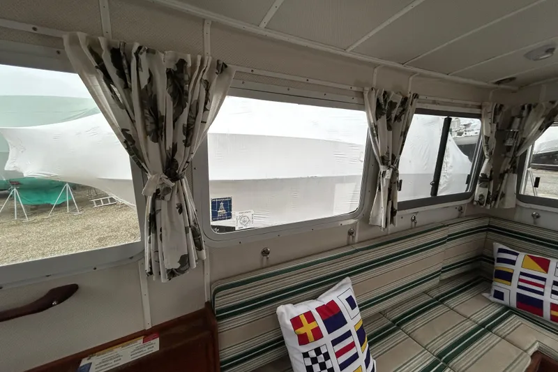 Slide: The Image of Interior of a 1973 Willard 30 boat with striped seating and nautical-themed pillows. - 66