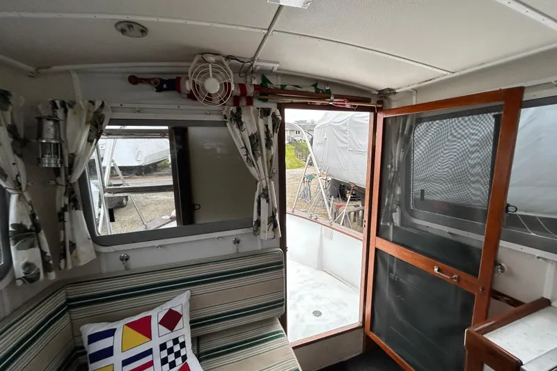 Slide: The Image of Interior of a 1973 Willard 30 boat with striped seating and nautical decor. - 67