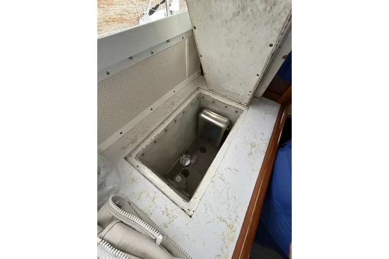 Slide: The Image of 1973 Willard 30 boat interior with open storage compartment. - 69