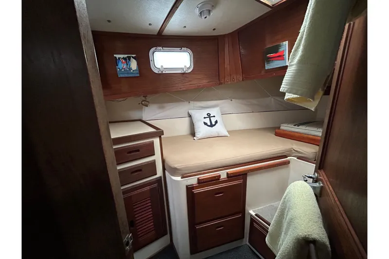Slide: The Image of Cozy cabin interior of a 1973 Willard 30 boat with anchor-themed decor. - 7