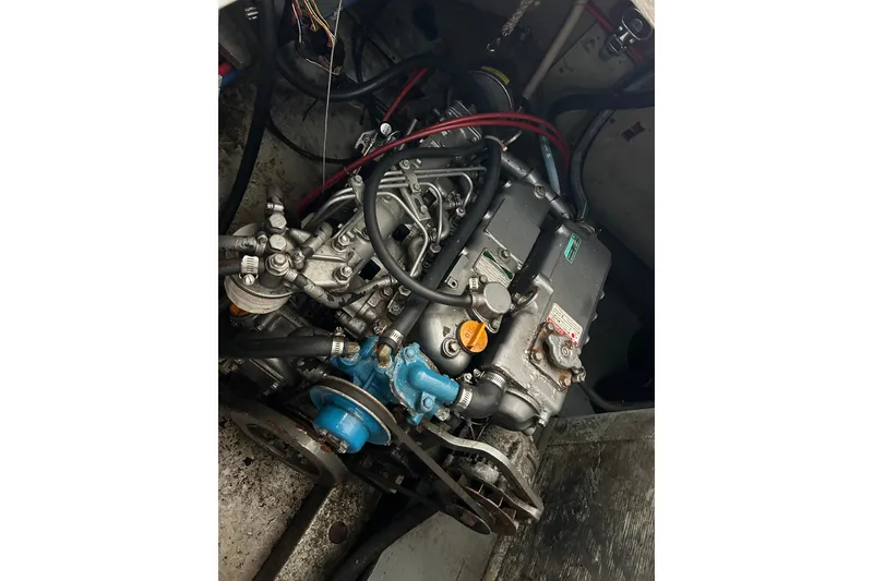 Slide: The Image of 1973 Willard 30 engine with visible components and wiring in a boat's engine compartment. - 8