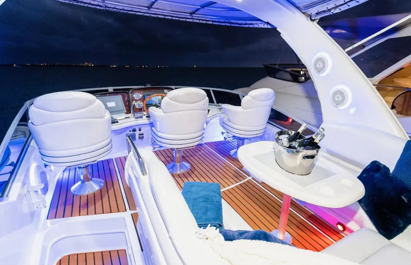 Slide: The Image of Luxurious 2006 Sea Ray 44 Sedan Bridge yacht interior with elegant seating and ambient lighting. - 13