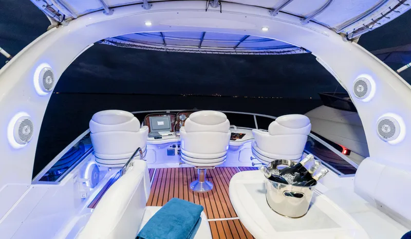 Slide: The Image of Luxurious 2006 Sea Ray 44 Sedan Bridge yacht interior with elegant seating and ambient lighting. - 14