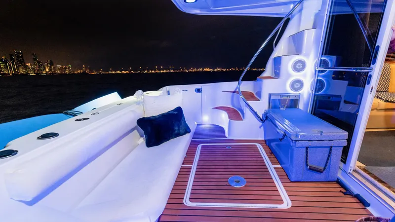 Slide: The Image of Luxurious 2006 Sea Ray 44 Sedan Bridge yacht deck with city skyline at night. - 15