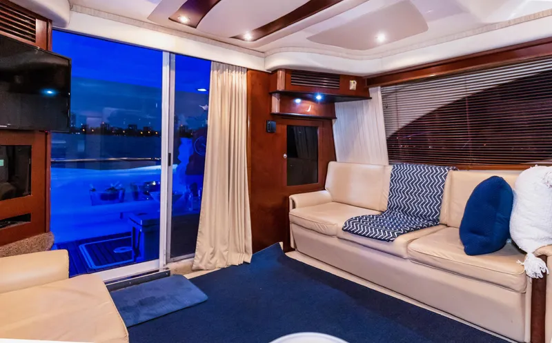 Slide: The Image of Luxurious interior of 2006 Sea Ray 44 Sedan Bridge yacht with cozy seating and ambient lighting. - 19