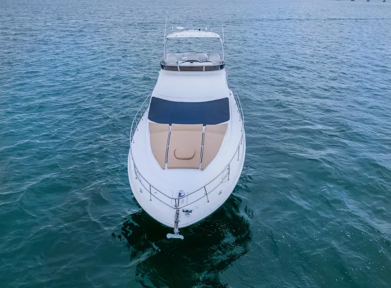 Slide: The Image of 2006 Sea Ray 44 Sedan Bridge yacht on open water, aerial view. - 2